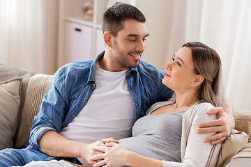 Image showing man hugging pregnant woman at home