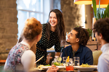 Image showing happy friends eating at restaurant