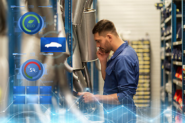 Image showing auto mechanic with clipboard at car workshop