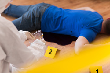 Image showing criminalist collecting crime scene evidence