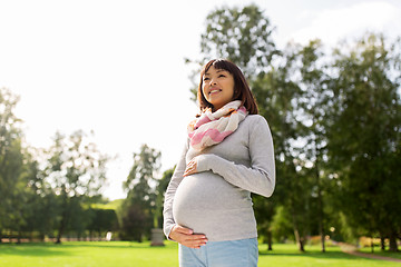 Image showing happy pregnant asian woman at park