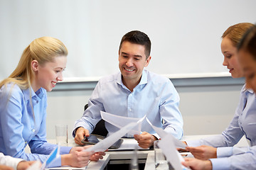 Image showing happy business team with papers at office