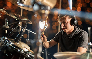 Image showing male musician playing drum kit at concert