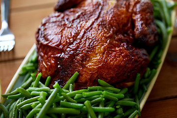 Image showing close up of roast chicken with green beans