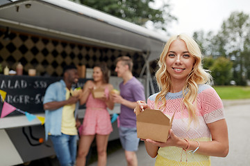 Image showing happy woman with wok and friends at food truck