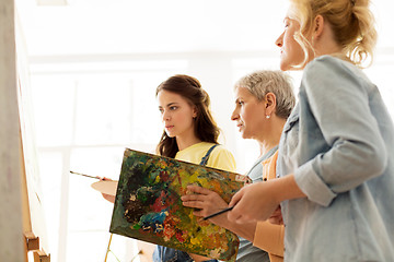 Image showing women with brushes painting at art school