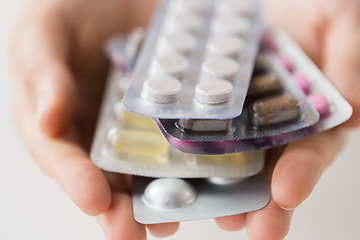 Image showing woman hands holding packs of pills