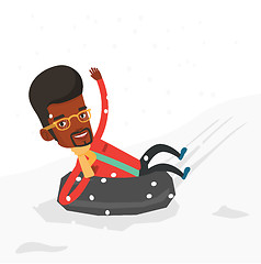 Image showing Man sledding on snow rubber tube in mountains.
