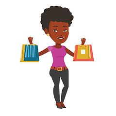 Image showing Happy woman holding shopping bags.