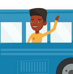 Image showing Man waving hand from bus window.