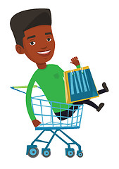 Image showing Happy man riding by shopping trolley.