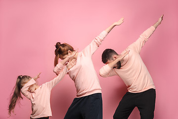Image showing The dancing young family on pink