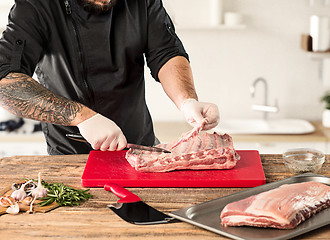 Image showing Man cooking meat steak on kitchen