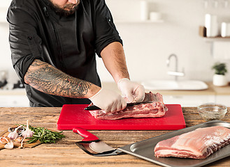 Image showing Man cooking meat steak on kitchen