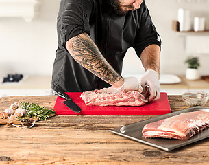 Image showing Man cooking meat steak on kitchen