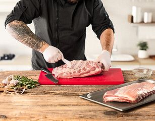 Image showing Man cooking meat steak on kitchen