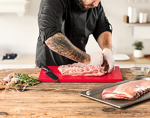 Image showing Man cooking meat steak on kitchen