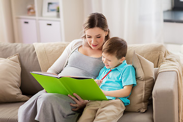 Image showing pregnant mother and little son with book at home