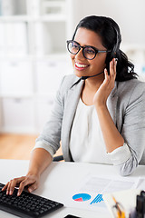 Image showing businesswoman with headset and keyboard at office