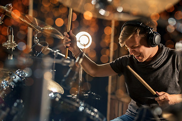 Image showing male musician playing drum kit at concert