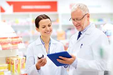 Image showing apothecaries with tablet pc and drug at pharmacy