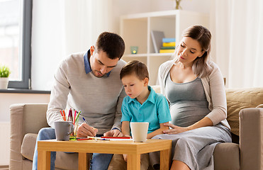 Image showing father, pregnant mother and son drawing at home