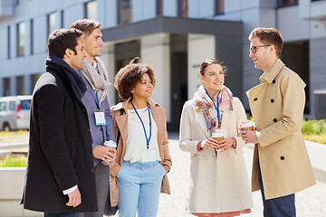 Image showing business team with conference badges and coffee