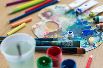 Image showing palette, brushes and paint tubes on table