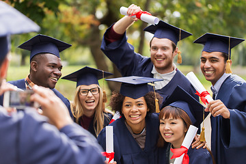 Image showing students or graduates with diplomas taking picture