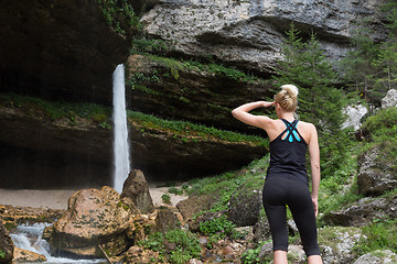 Image showing Active sporty woman under a Pericnik waterfall, Slovenia.