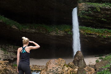 Image showing Active woman looking at Pericnik waterfall in Vrata Valley in Triglav National Park in Julian Alps, Slovenia.