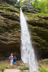 Image showing Active tourists looking at Pericnik waterfall in Vrata Valley in Triglav National Park in Julian Alps, Slovenia.