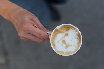 Image showing Hand holding a cup of coffee to go.