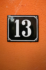 Image showing the number thirteen on an orange wall