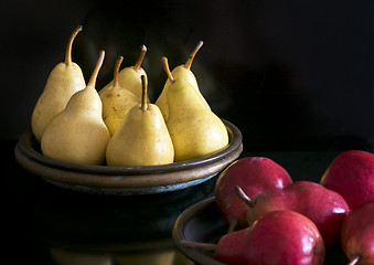 Image showing Several yellow and red pears in bowls