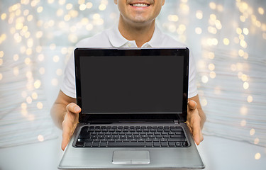 Image showing close up of happy man showing laptop