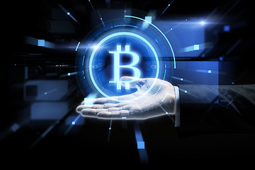 Image showing close up of businessman hand with bitcoin symbol