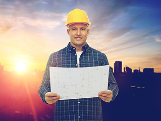 Image showing male builder in yellow hard hat with blueprint