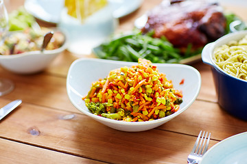 Image showing vegetable salad with corn and other food on table