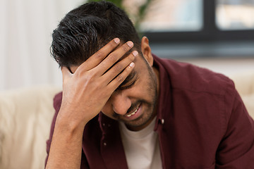 Image showing close up of man suffering from head ache at home