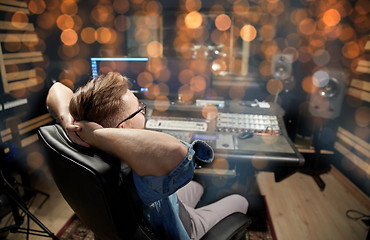 Image showing man at mixing console in music recording studio