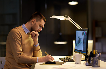 Image showing man with notepad working at night office