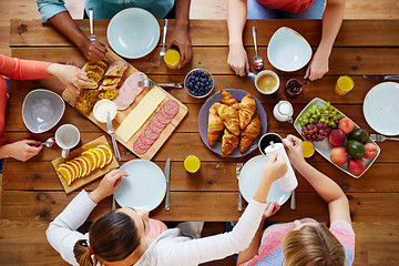 Image showing group of people having breakfast at table