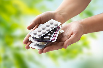 Image showing woman hands holding packs of pills