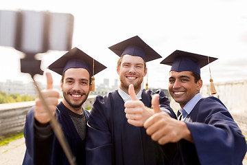 Image showing happy male students or graduates taking selfie