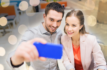 Image showing happy couple taking selfie with smartphone in cafe