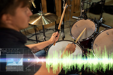 Image showing male musician playing drum kit at concert