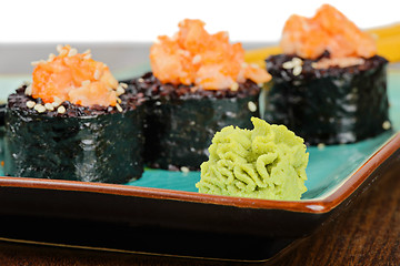 Image showing Baked sushi rolls served on turquoise plate