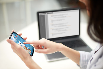 Image showing close up of woman with business news on smartphone