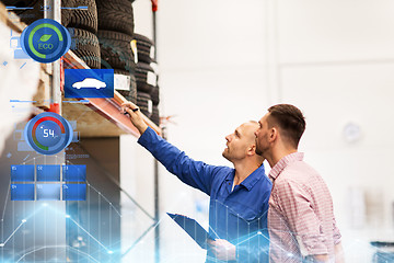 Image showing auto mechanic with clipboard and man at car shop